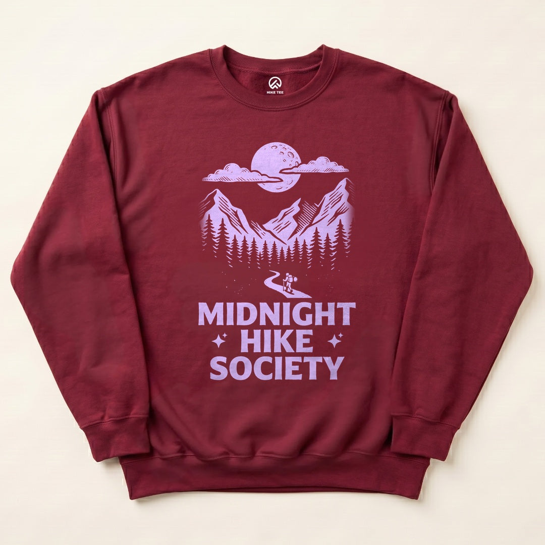 Maroon Midnight Hike Society Sweatshirt with a full moon over the mountains and a night hiker graphic