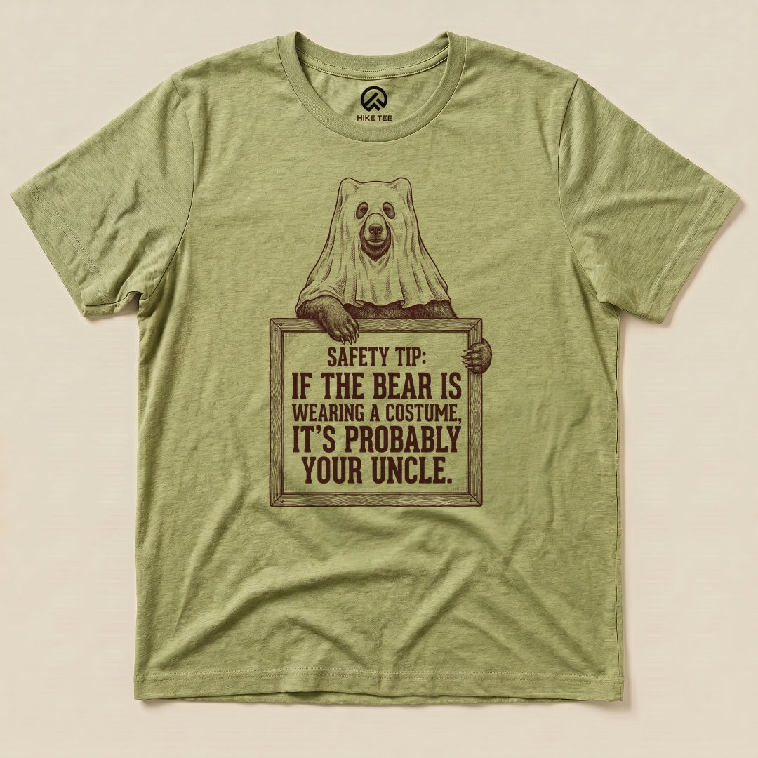 Heather Green Bear Safety Tip Shirt with a bear in a ghost sheet holding a safety tip sign graphic