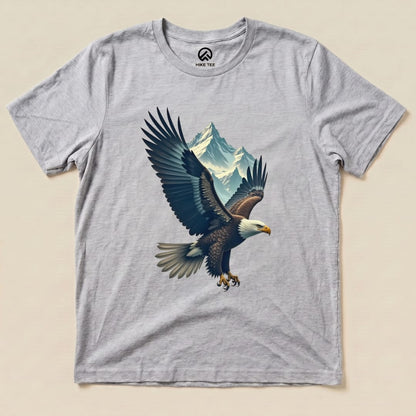 A graphic t-shirt featuring an eagle in flight with mountains in the background, labeled as the "Eagle and Mountain Shirt.