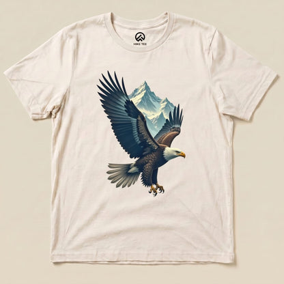 A graphic t-shirt featuring an eagle in flight against a backdrop of mountains, labeled as the "Eagle and Mountain Shirt.