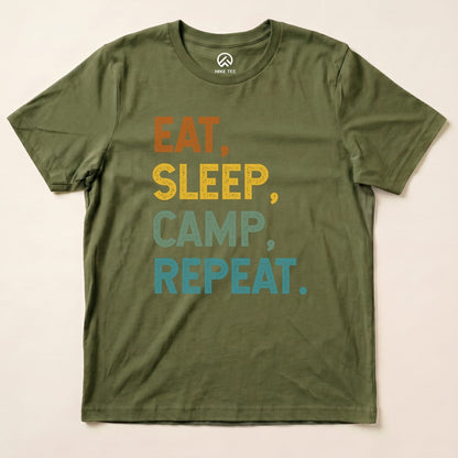 The image features an olive green graphic t-shirt displaying the slogan "EAT, SLEEP, CAMP, REPEAT." in vibrant colors.