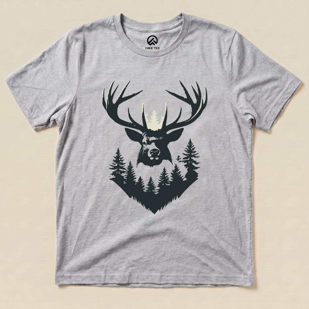 A graphic t-shirt featuring an elk's head with prominent antlers surrounded by trees, showcasing the "Elk Shape Shirt" design.