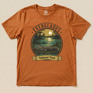 A graphic t-shirt featuring an illustration of an alligator in the Everglades with "Everglades National Park" printed below.
