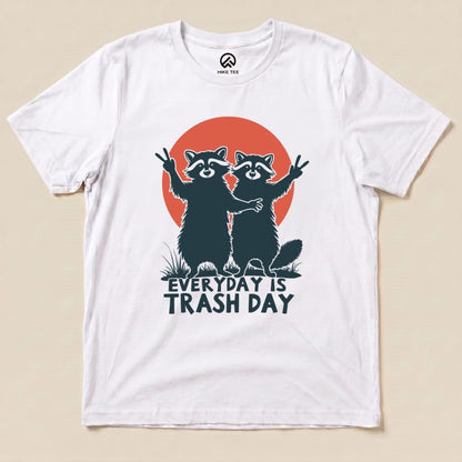 A graphic t-shirt featuring two playful raccoons with raised peace signs and the text "Everyday is Trash Day" set against an orange circle.