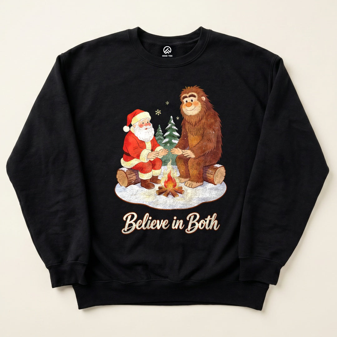 Black Believe in Both Sweatshirt with a Santa and Bigfoot warming up by a campfire graphic