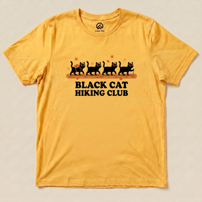 Gold Black Cat Hiking Club Shirt with a row of black cats walking on a log with autumn leaves graphic