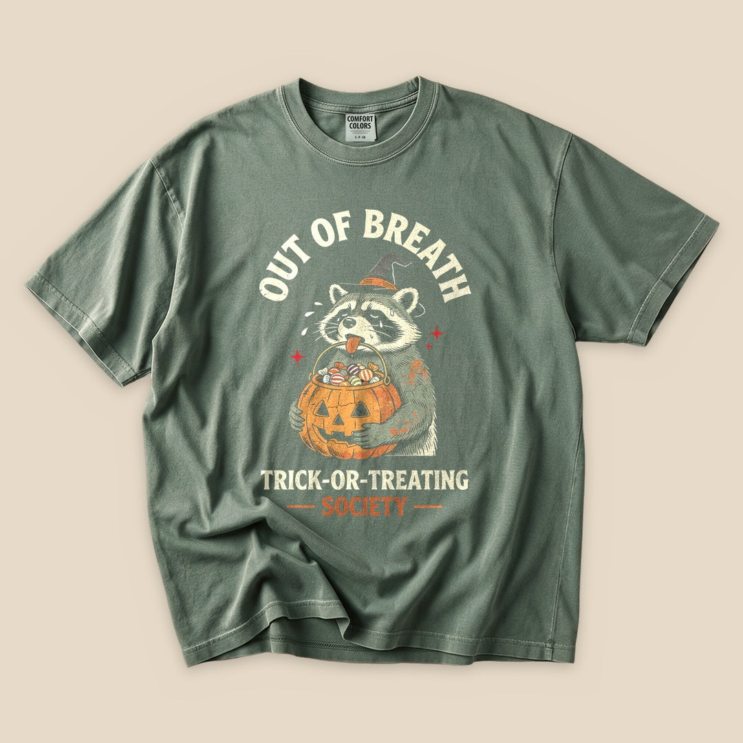 Moss Out of Breath Trick-or-Treating Society T-Shirt with a raccoon with a jack-o'-lantern trick-or-treating graphic