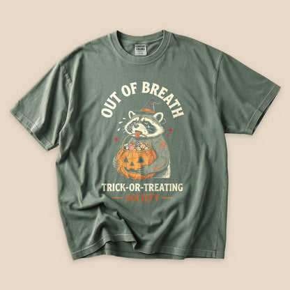 Moss Out of Breath Trick-or-Treating Society T-Shirt with a raccoon with a jack-o'-lantern trick-or-treating graphic