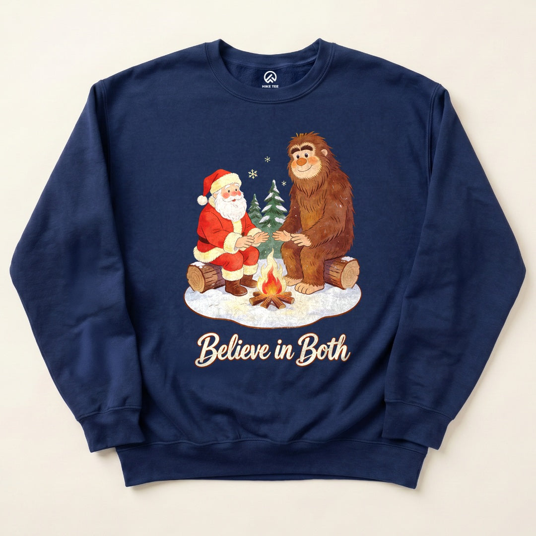 Navy Believe in Both Sweatshirt with a Santa and Bigfoot warming up by a campfire graphic