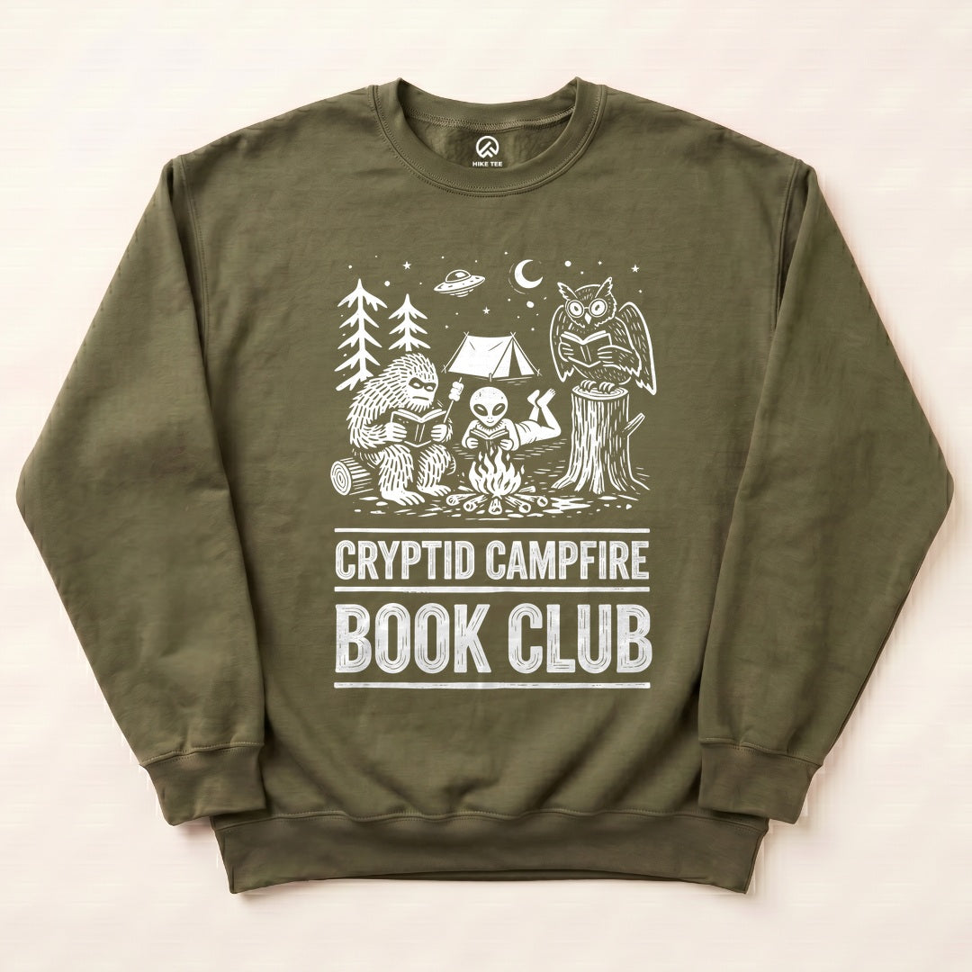 Military Green Cryptid Campfire Book Club Sweatshirt with a Bigfoot and friends reading around a campfire graphic