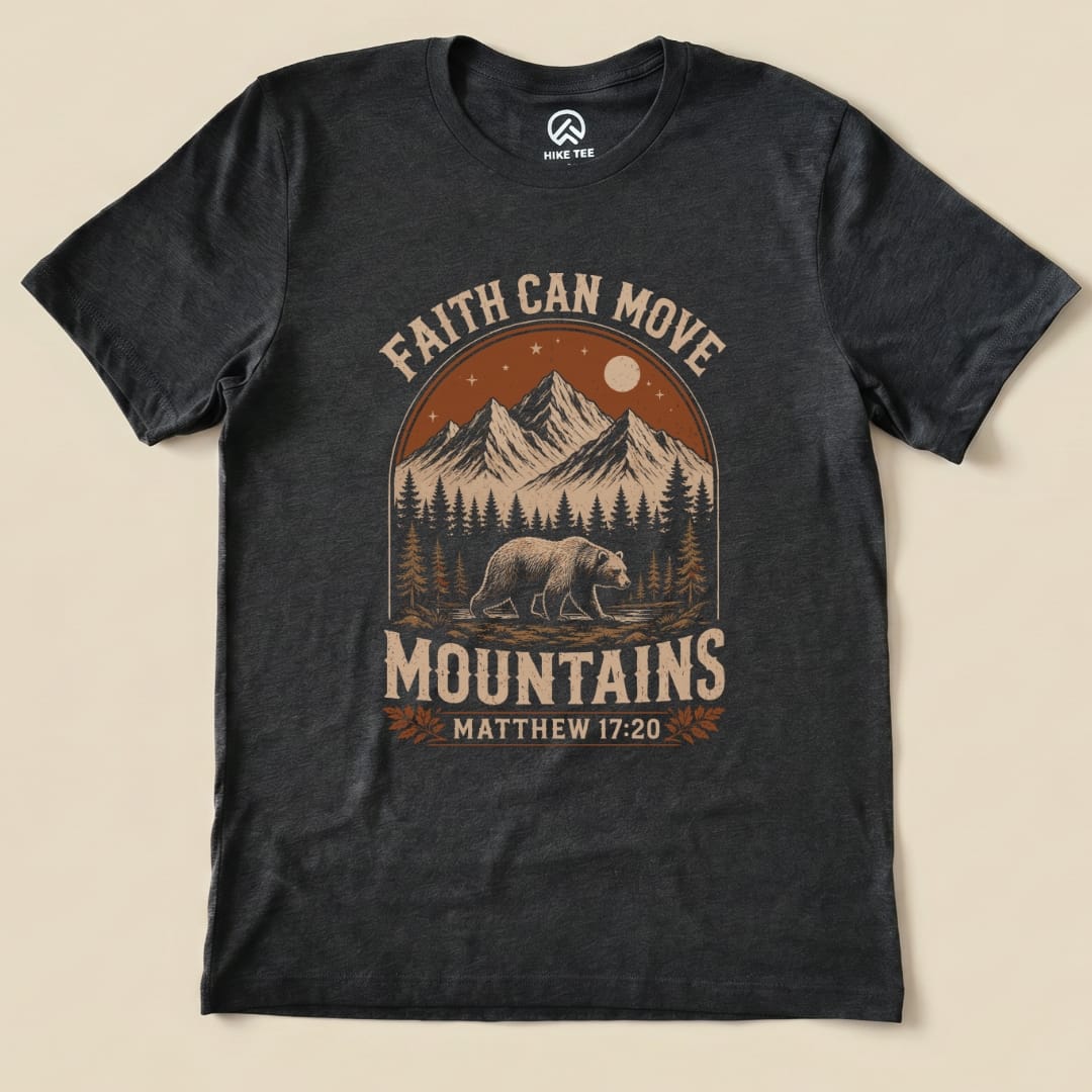 Graphic t-shirt featuring a bear, mountains, and the phrase "Faith Can Move Mountains" along with "Matthew 17:20".