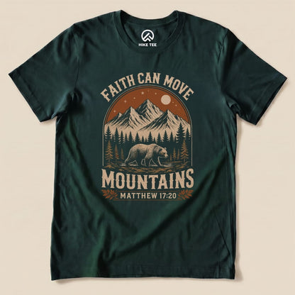 A dark green graphic t-shirt featuring the phrase "Faith Can Move Mountains" with a scenic mountain design and a bear.