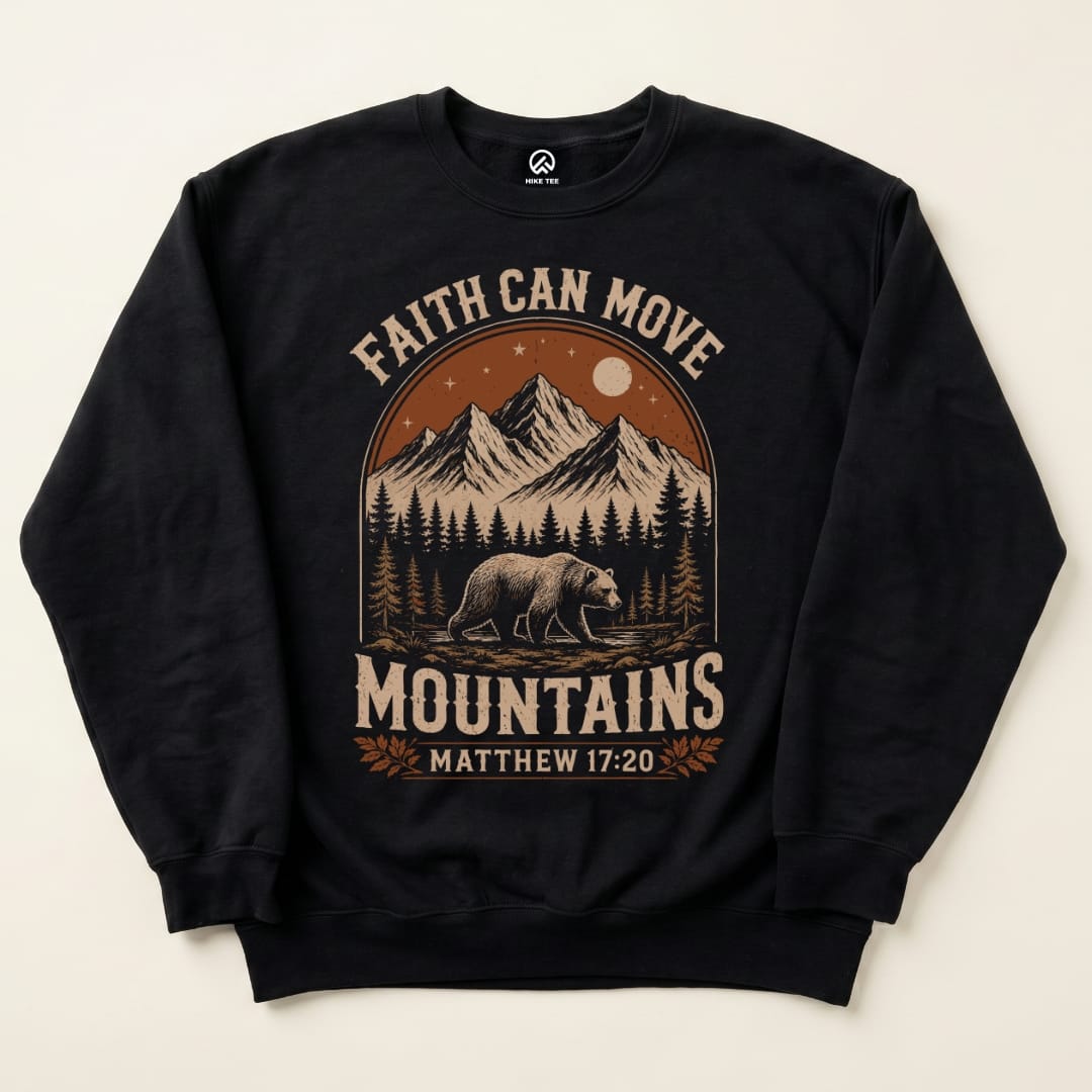 A black sweatshirt featuring the graphic "Faith Can Move Mountains" alongside a bear and mountainous scenery.