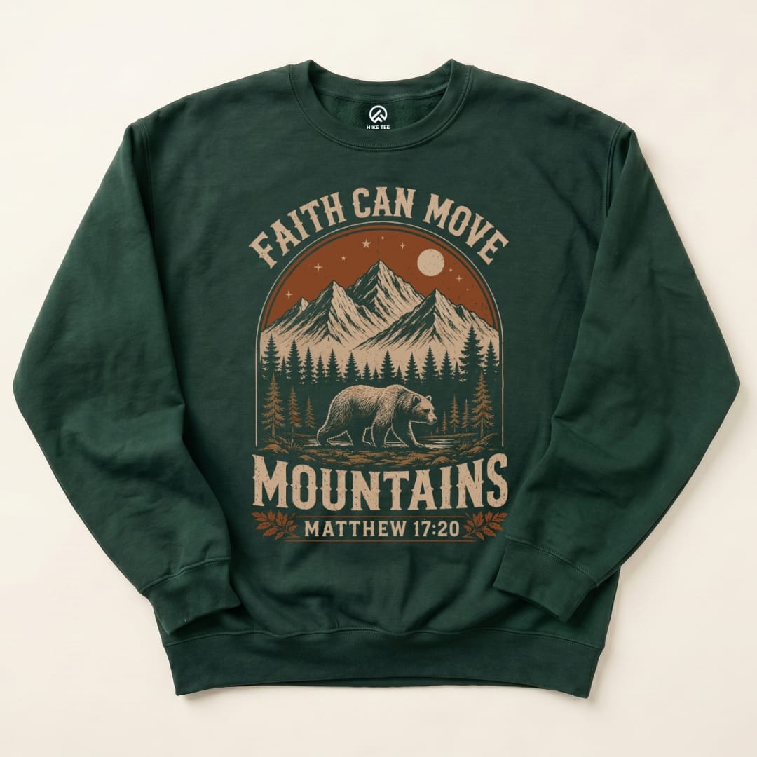 The dark green "Faith Can Move Mountains Sweatshirt" features a bear walking beneath scenic mountains and the slogan above.