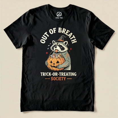 Black Out of Breath Trick-or-Treating Society Shirt with a raccoon witch holding a pumpkin full of candy graphic