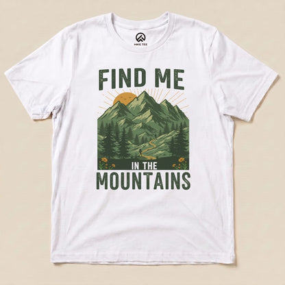 The graphic t-shirt features a design with mountains, trees, and the slogan “Find Me In The Mountains” printed prominently.