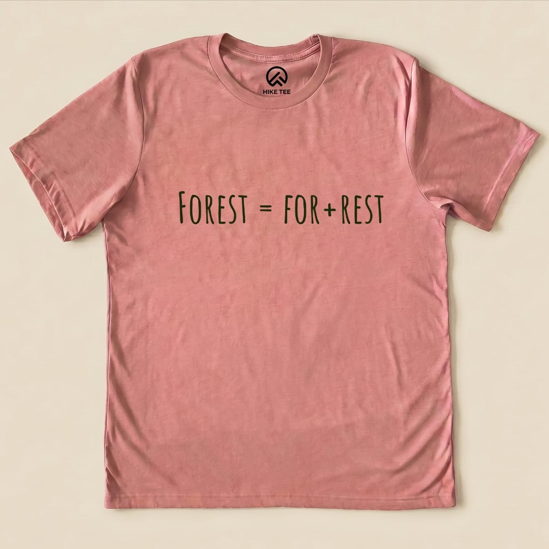 A light pink graphic t-shirt featuring the slogan "Forest = For + Rest" prominently displayed in dark text.