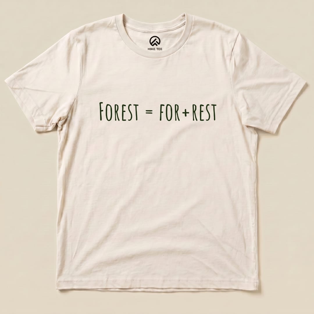 A flat lay of the Forest For Rest Shirt featuring the playful text "FOREST = FOR + REST" in green on a light background.