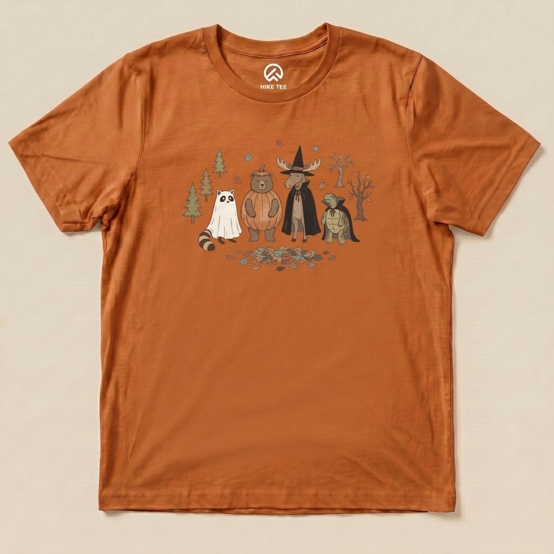 The Forest Friends Costume Party Shirt features whimsical animal characters dressed for a costume party against a nature backdrop.