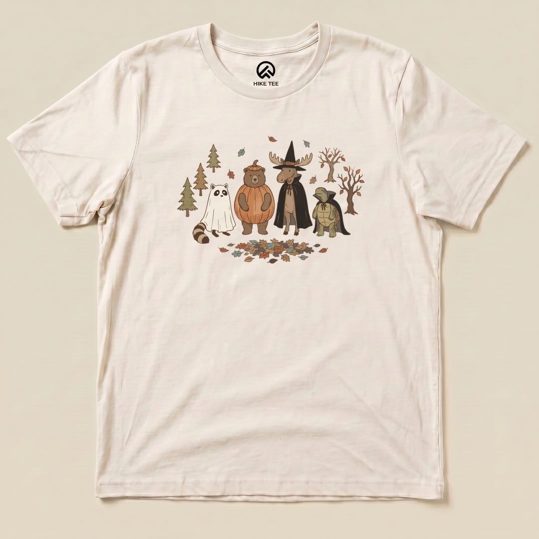 The graphic t-shirt features a whimsical "Forest Friends Costume Party Shirt" design with cartoon animals in costumes among trees and leaves.