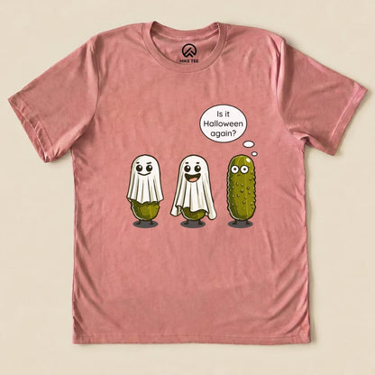 A pink graphic t-shirt featuring a Funny Pickle Ghost Shirt design with three ghostly pickles and the speech bubble, "Is it Halloween again?