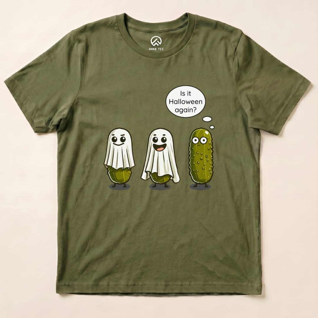 A graphic t-shirt featuring three cartoon pickle ghosts, two wearing bedsheets, with the text "Is it Halloween again?