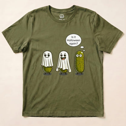 A graphic t-shirt featuring three cartoon pickle ghosts, two wearing bedsheets, with the text "Is it Halloween again?