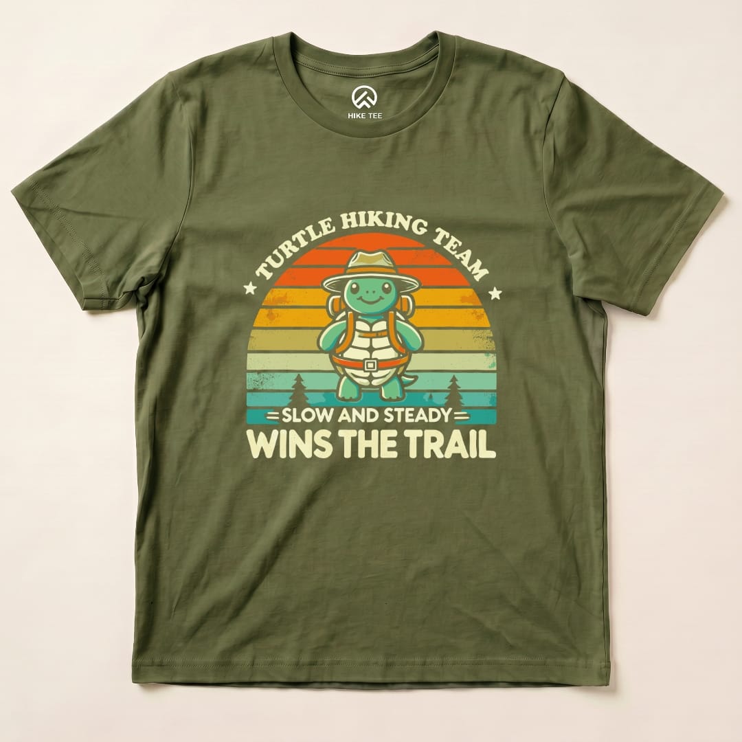 The graphic t-shirt features a turtle character with a backpack and a hat, stating "Turtle Hiking Team - Slow and Steady Wins the Trail.