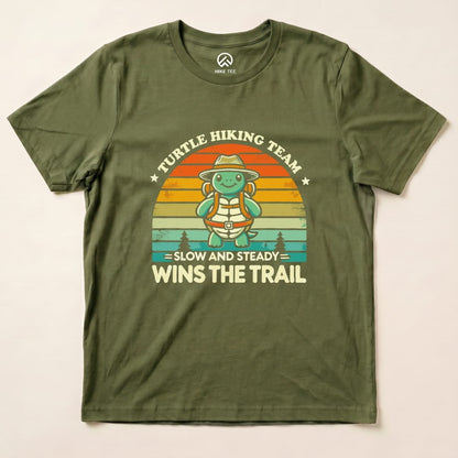 The graphic t-shirt features a turtle character with a backpack and a hat, stating "Turtle Hiking Team - Slow and Steady Wins the Trail.