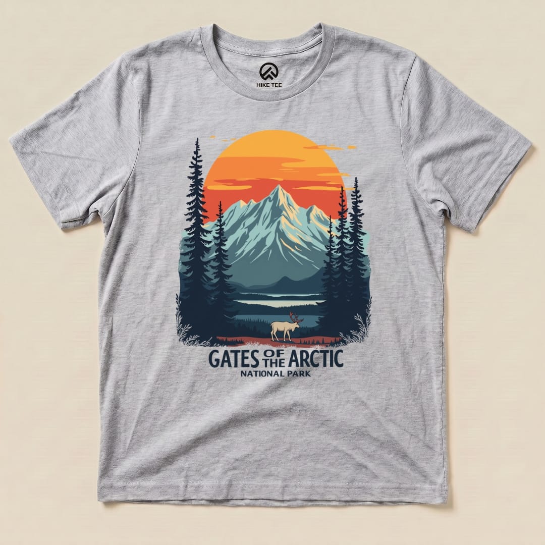 A graphic t-shirt featuring a scenic depiction of mountains and trees with the text "Gates of the Arctic National Park.