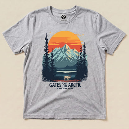 A graphic t-shirt featuring a scenic depiction of mountains and trees with the text "Gates of the Arctic National Park.