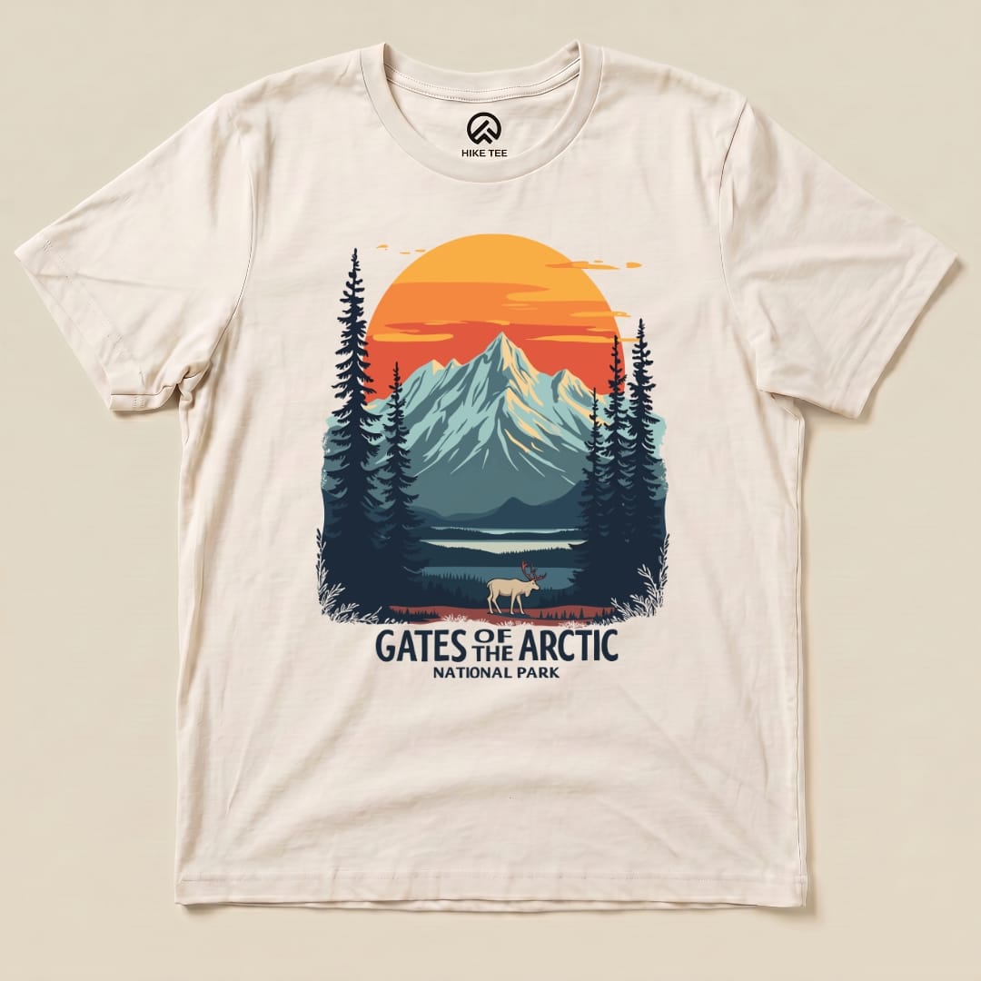 A graphic t-shirt featuring a scenic design of mountains, trees, and a caribou, labeled "Gates of the Arctic National Park Shirt.