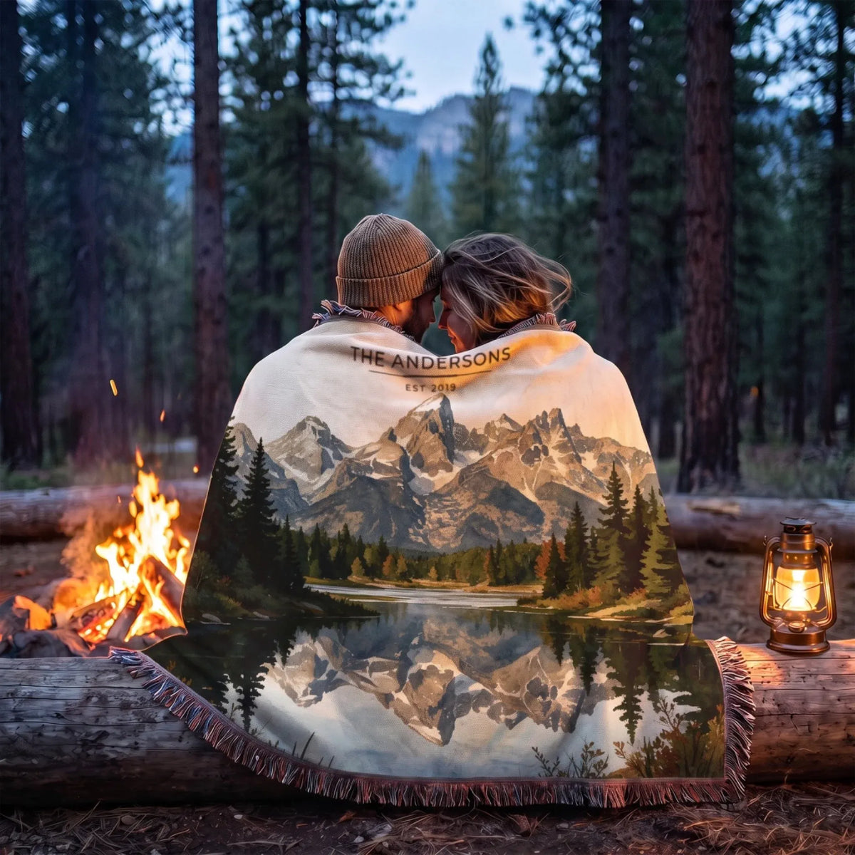 Couple wrapped in the Grand Teton Schwabacher Landing Woven Blanket by a campfire