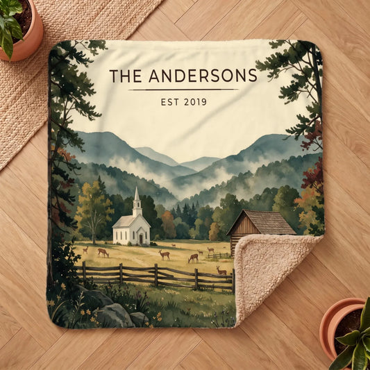 A graphic Sherpa blanket featuring a tranquil scene of the Great Smoky Mountains Cades Cove with a church and deer.