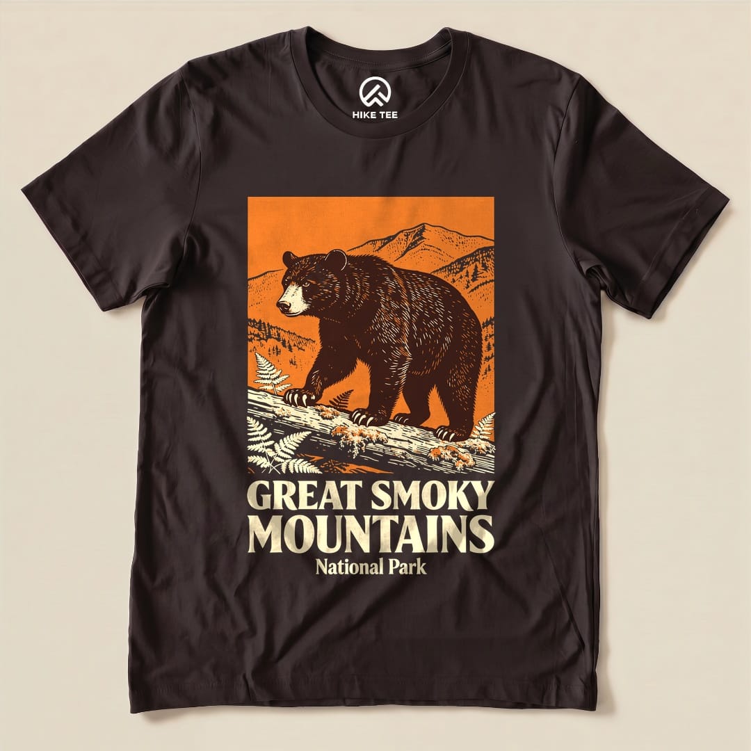 A graphic t-shirt featuring a bear walking on a log with the text "Great Smoky Mountains National Park" prominently displayed.