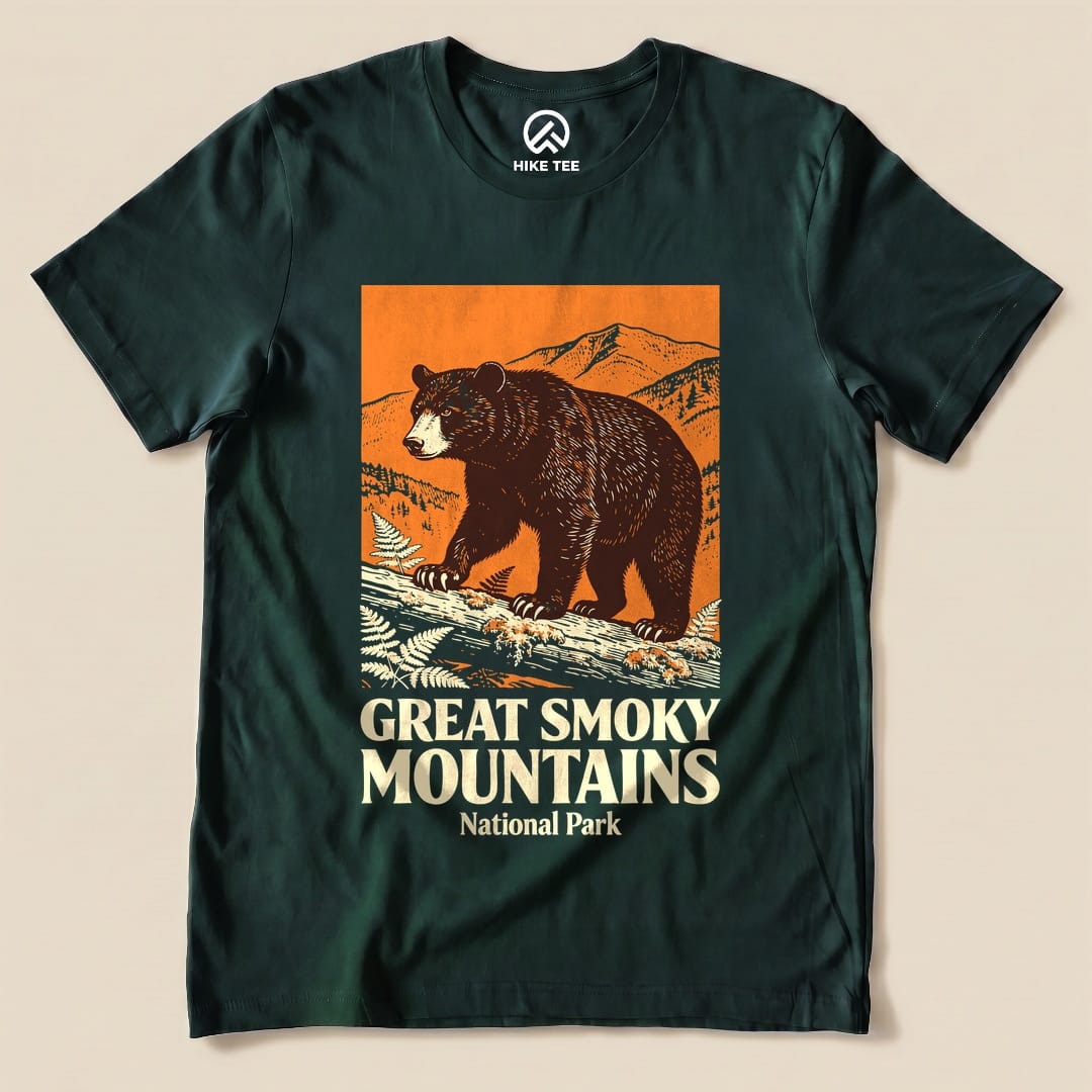 A graphic t-shirt featuring a bear and mountain landscape with the text "Great Smoky Mountains National Park Shirt".