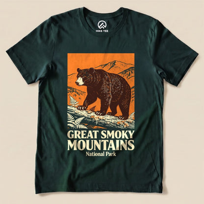 A graphic t-shirt featuring a bear and mountain landscape with the text "Great Smoky Mountains National Park Shirt".