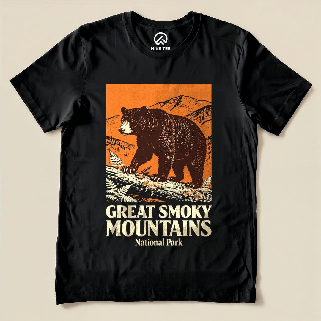 A graphic t-shirt featuring a bear on a log with mountains in the background and the text "Great Smoky Mountains National Park Shirt.