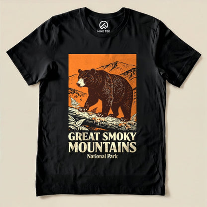 A graphic t-shirt featuring a bear on a log with mountains in the background and the text "Great Smoky Mountains National Park Shirt.