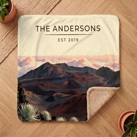 A cozy Haleakala Crater Sunrise Sherpa Blanket featuring a stunning landscape design with mountains and clouds.