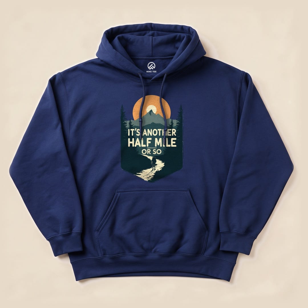 Navy blue Half Mile Hoodie featuring a graphic of a hiker on a winding path with the slogan "IT'S ANOTHER HALF MILE OR SO.