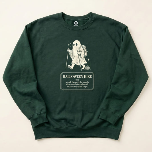 A dark green sweatshirt featuring a ghost character with a backpack and pumpkin, displaying the text "Halloween Hike Definition.