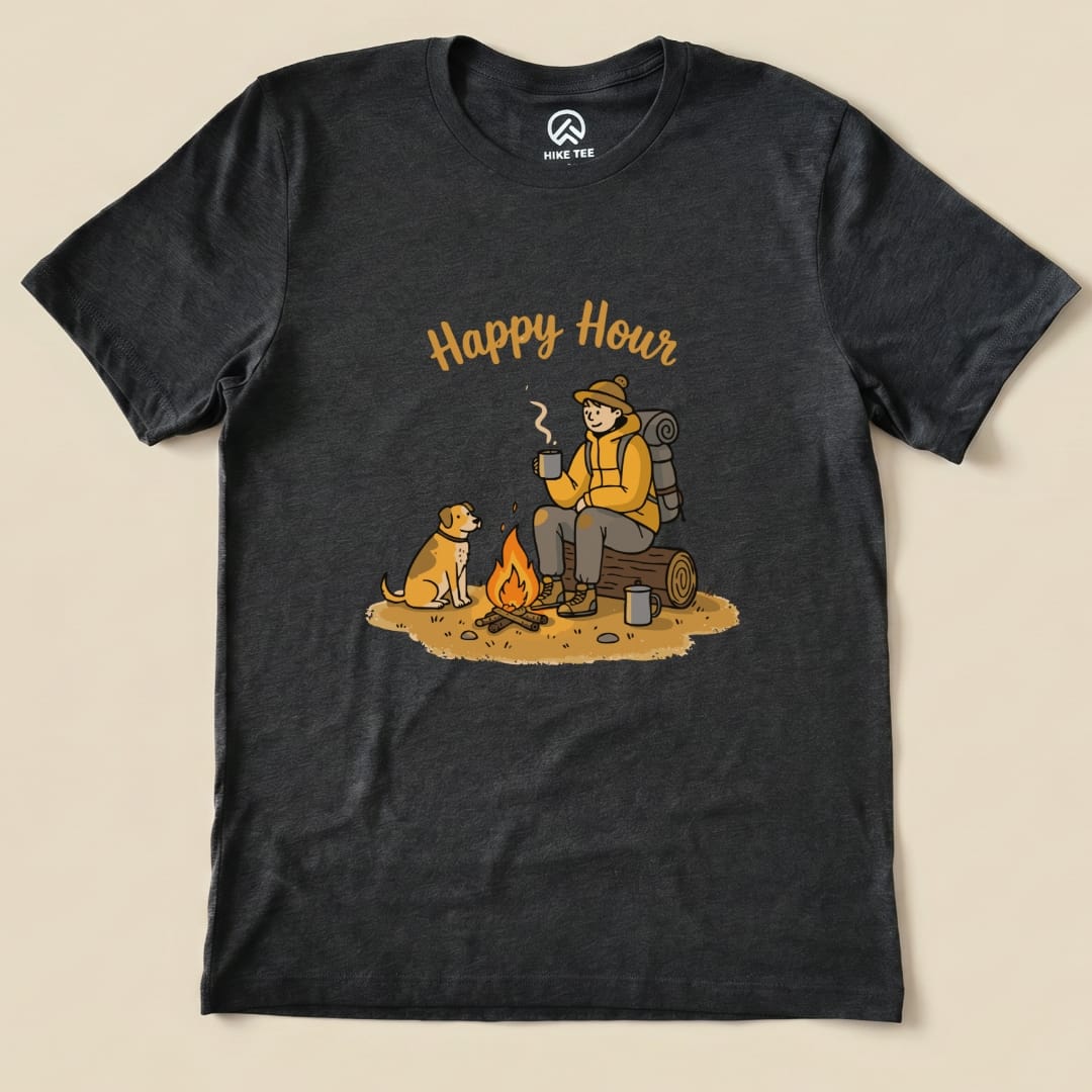 A graphic t-shirt featuring a camper sitting by a fire with a dog, accompanied by the text "Happy Hour.