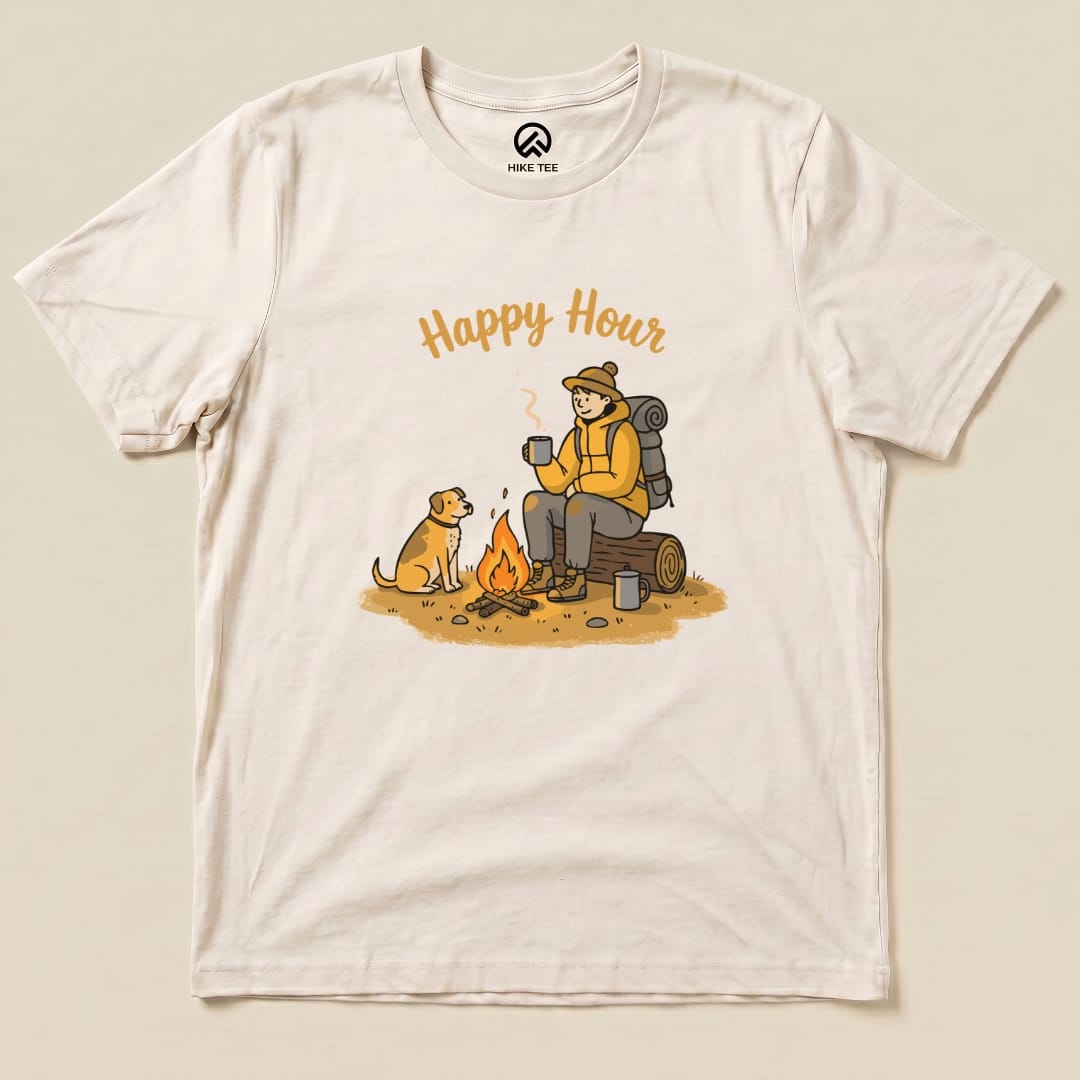 A graphic t-shirt depicting a camper enjoying "Happy Hour" with a dog by a campfire, surrounded by camping gear.