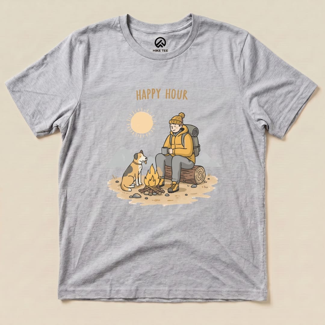 Graphic t-shirt featuring a camper sitting by a campfire with a dog, adorned with the words "HAPPY HOUR" and a sun graphic.
