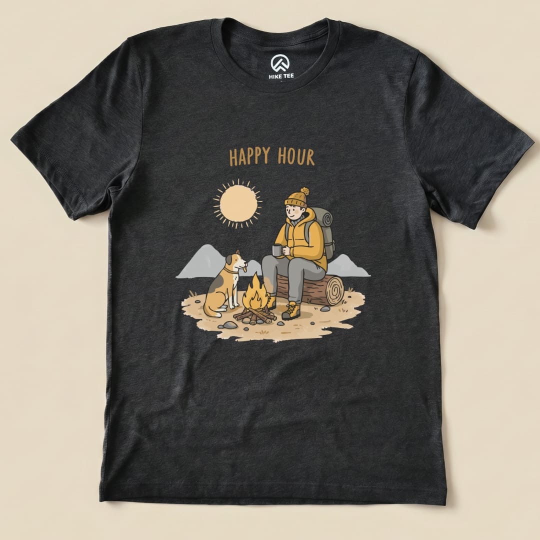 A graphic t-shirt featuring a camper sitting by a fire with a dog, showcasing the words "HAPPY HOUR" above the scene.