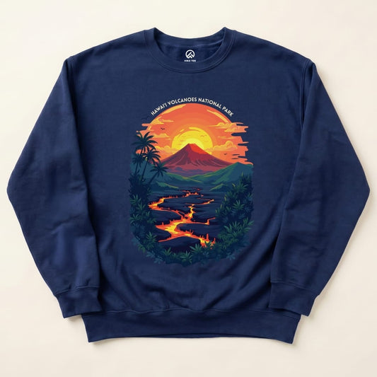 A navy sweatshirt featuring a vibrant graphic of a sunset over a volcano, with "Hawai'i Volcanoes National Park" text above.