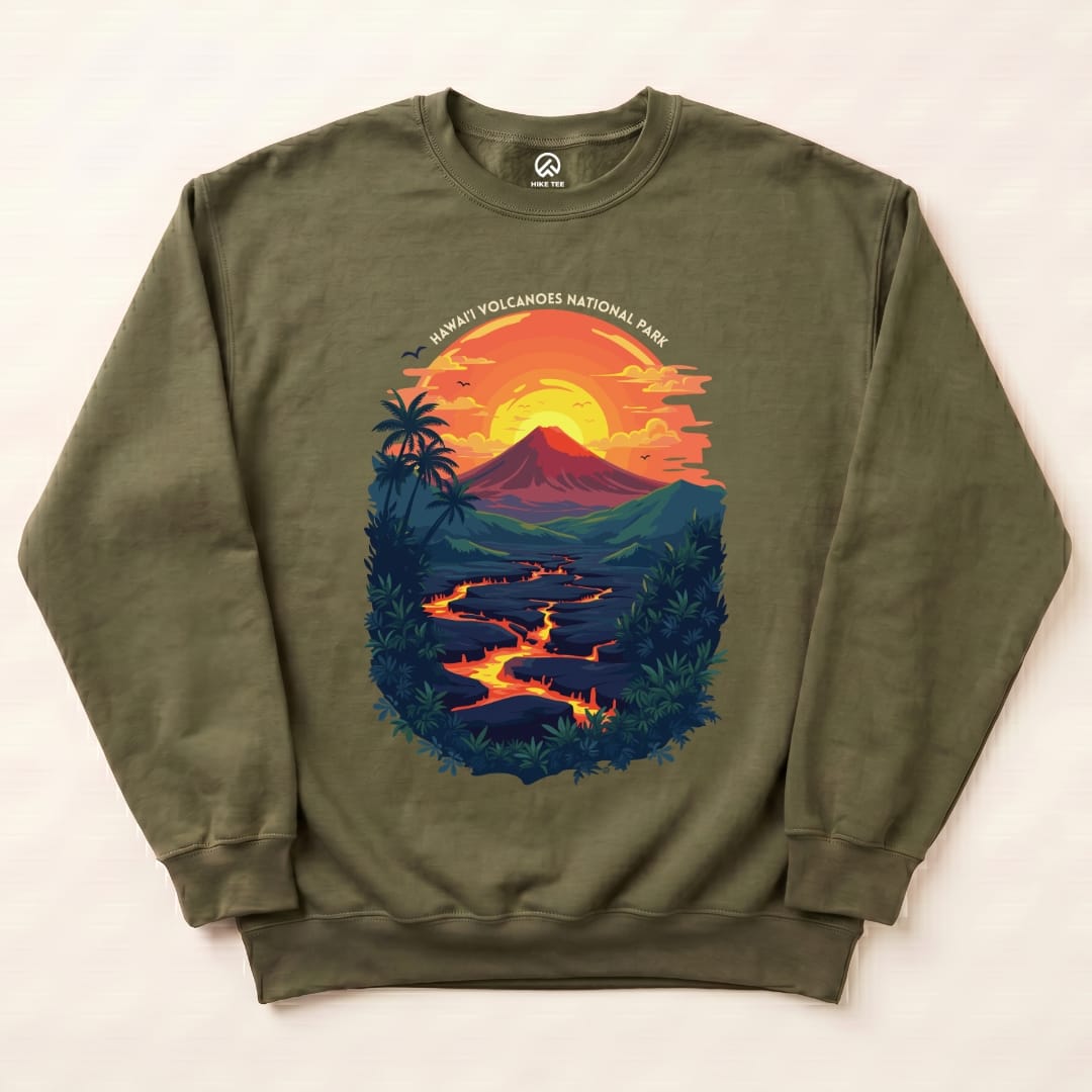 The graphic on the Hawai'i Volcanoes National Park Sweatshirt features a vibrant scene with a volcano, flowing lava, and a sunset backdrop.