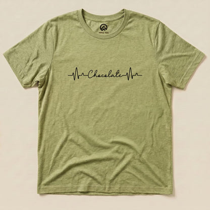 A flat olive green graphic t-shirt featuring the text "Chocolate" with a heartbeat line design.