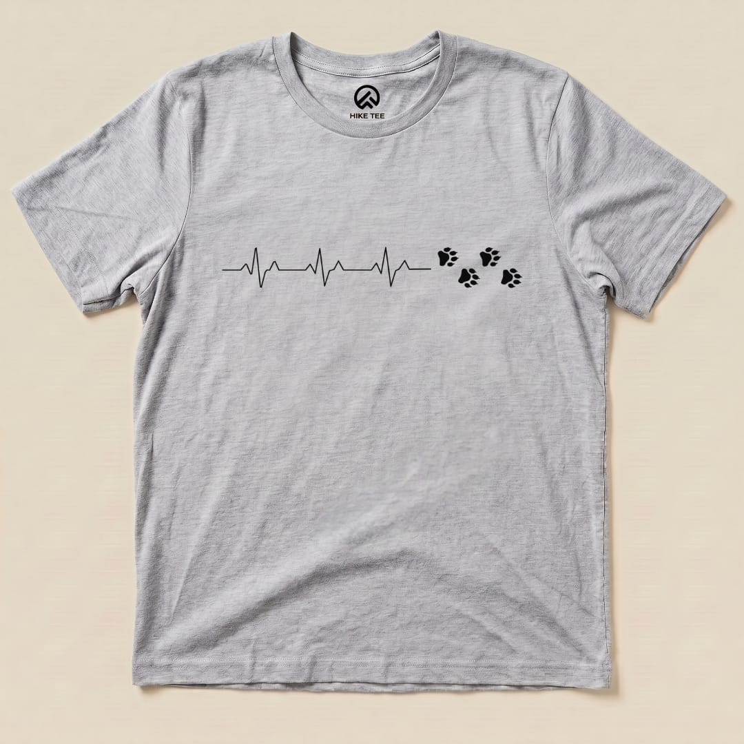 The Heart Beat Faws Shirt features a heartbeat line and animal paw prints printed on a heather gray graphic t-shirt.